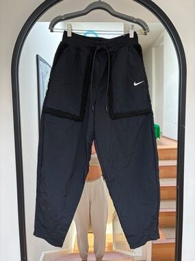 Nike Black Track Pants with Swoosh Tag, Fleece Pocket Detail, and Drawstring